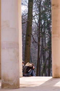 Girls in a park pavilion, spring sunlight