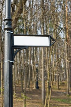 Signpost, white arrow at a park column