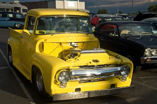 A classic yellow 50s Ford hotrod pickup