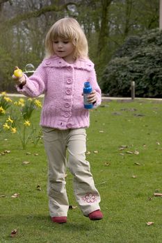 Little girl blowing soap bubbles