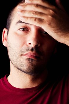 Close detail view of a young male man with a fever isolated on a black background.