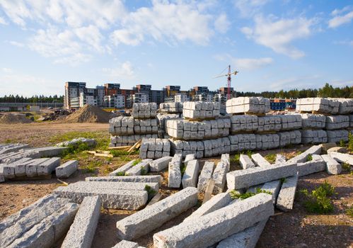 Stacks of street stones brought to a new suburb area yet under construction