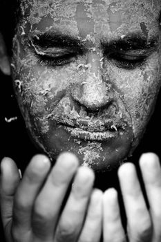 Close up view of a man's hands removing the mask from the face.