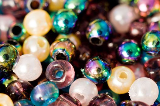 Macro photograph of tiny vibrant multi-hued plastic beads