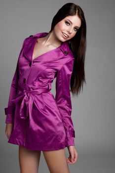 Young woman wearing purple raincoat