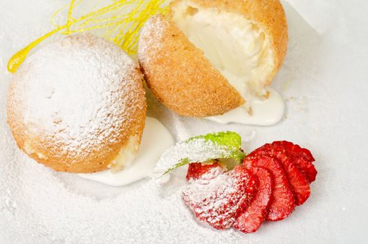 Dessert of ice-cream at biscuit with strawberry and caramel