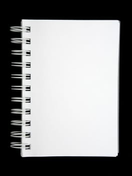 Open blank notebook on a black background