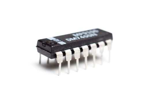 Closeup photograph of an single electronic integrated circuit chip on a white background