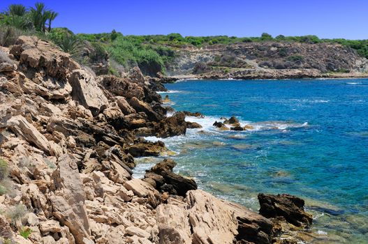 Rocky shore of the Mediterranean sea with clear water.