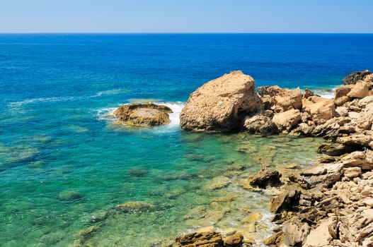 Rocky shore of the Mediterranean sea with clear water.