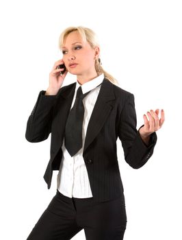 Girl in a business suit gestures while talking on a cell phone.