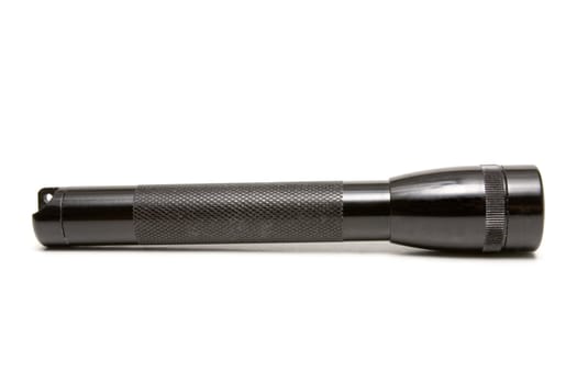 Black rugged aluminum flashlight on a white background