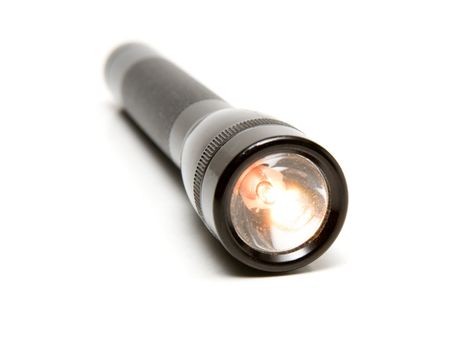 Black rugged aluminum flashlight on a white background