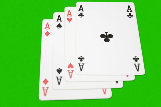 Winning playing cards, four aces, on green background