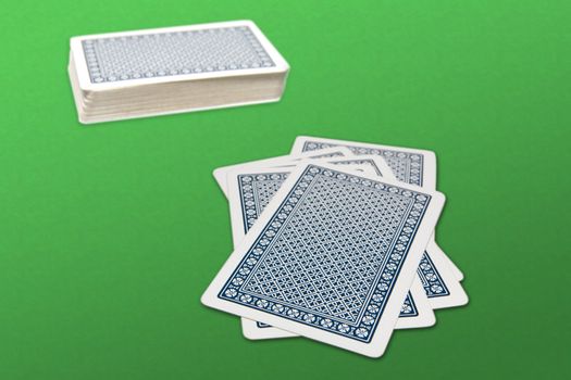 Deck and cards on a green background
