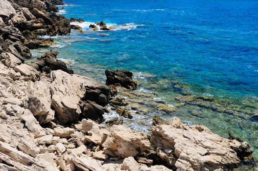 Rocky shore of the Mediterranean sea with clear water.