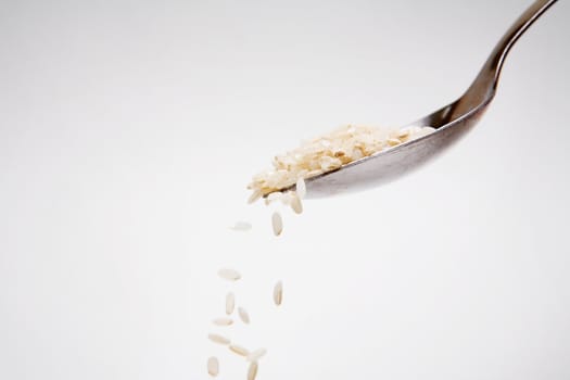 Rice falling down from a spoon