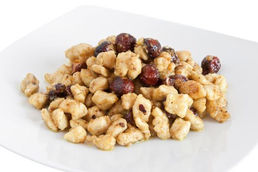 plate with chicken and nuts isolated on white background with clipping path
