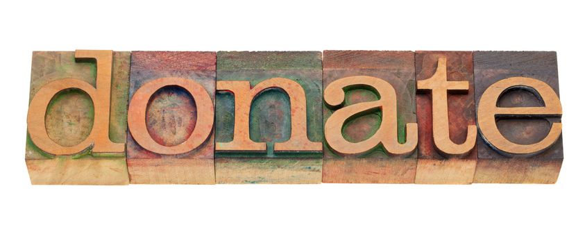 donate - word in vintage wooden letterpress printing blocks, stained by color inks, isolated on white