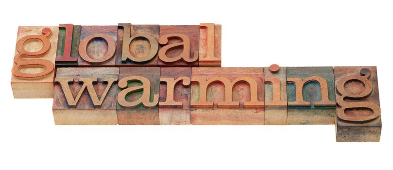 global warming  phrase in vintage wooden letterpress printing blocks, stained by color inks, isolated on white