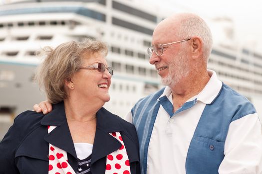 Senior Couple On Shore in Front of Cruise Ship While on Vacation.