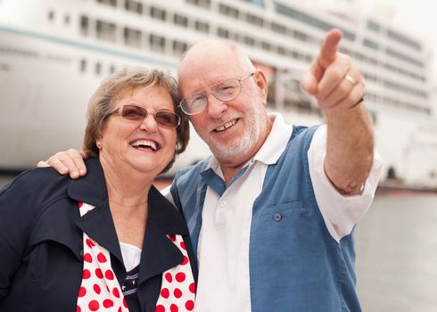 Senior Couple On Shore in Front of Cruise Ship While on Vacation.