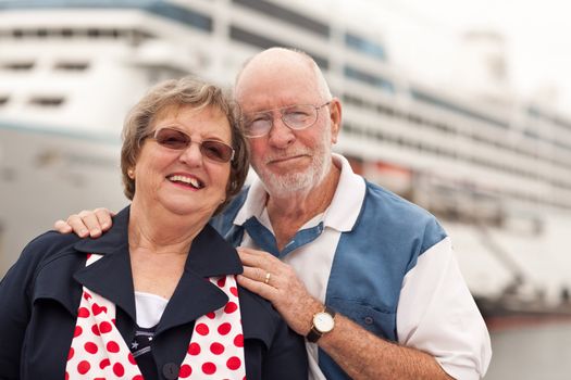 Senior Couple On Shore in Front of Cruise Ship While on Vacation.