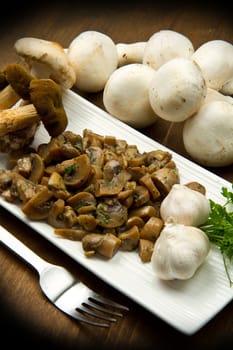 cooked and fresh mushrooms  with garlic and parsley