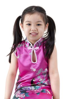 Little oriental girl in traditional Chinese dress cheongsam on white background