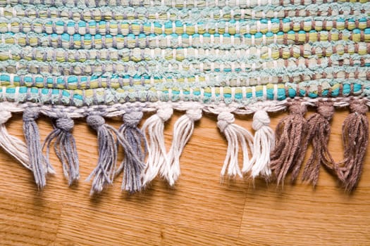 Woven carpet on a parquet floor