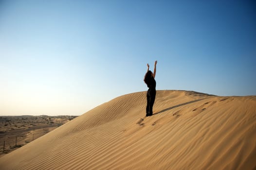 Woman enjoying the desert in Dubai, United Arab Emirates