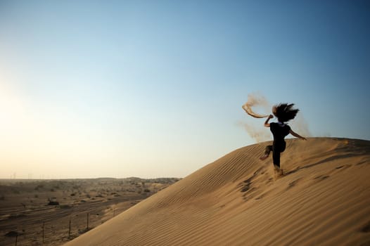 Woman enjoying the desert in Dubai, United Arab Emirates