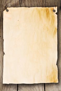 Blank sheet of paper attached to a wooden wall