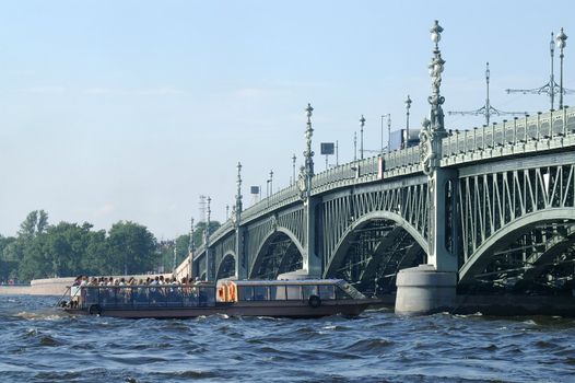Boat under Troitsky Bridge in Saint Petersburg, Russia.