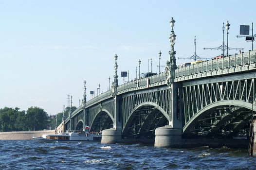 Boat under Troitsky Bridge in Saint Petersburg, Russia.