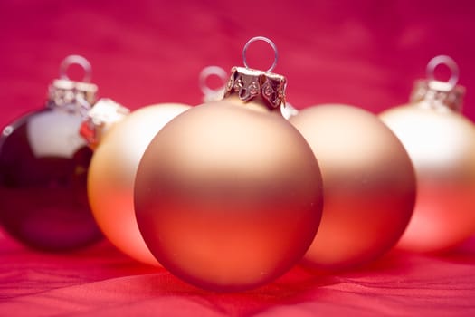 Glassy christmas baubles on red background