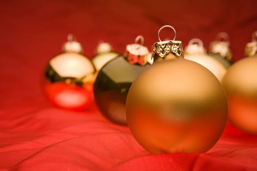 Glassy christmas baubles on red background