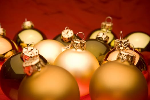 Glassy christmas baubles on red background