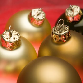 Glassy christmas baubles on red background