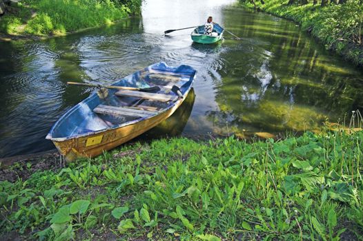 Boat at lake shore in summer park in Saint Petersburg, Russia