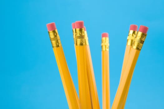 Yellow pencils on blue background