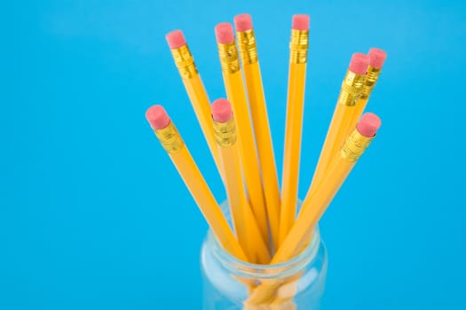 Yellow pencils on blue background