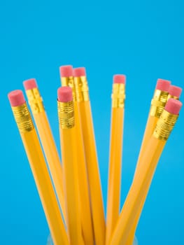 Yellow pencils on blue background