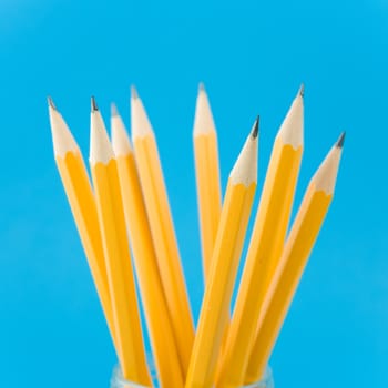 Yellow pencils on blue background