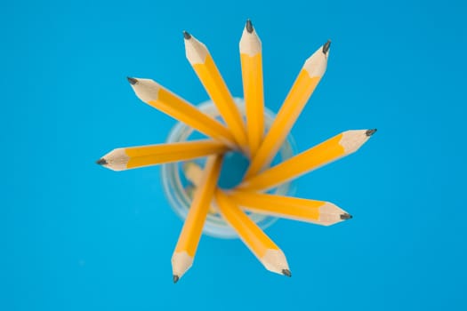 Yellow pencils on blue background