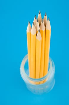 Yellow pencils on blue background