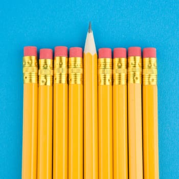 Yellow pencils on blue background