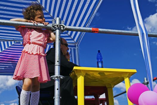 ST PETERSBURG - JUNE 28: Girl, 8, looks at carnival procession at Life in Pink festival June 28, 2008 in St Petersburg, Russia.