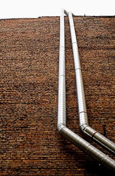 Pipework on a brick wall.