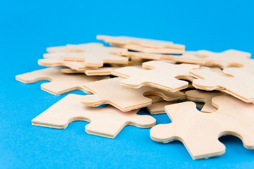 Wooden puzzle pieces on blue background